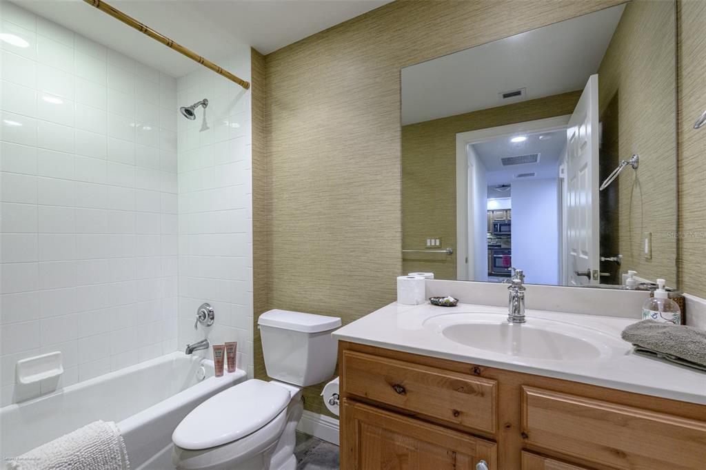 3313 Sunset Key Circle, Unit 104 Punta Gorda, FL 33955 - Photo 45 of 57 a bathroom with a sink a toilet a mirror and shower