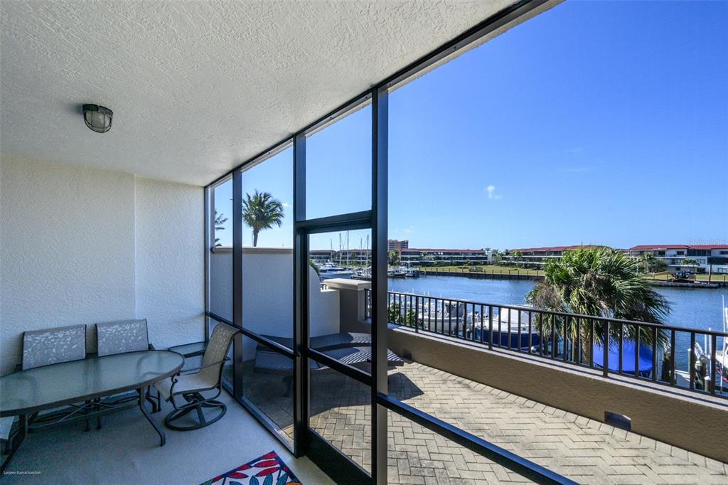 3313 Sunset Key Circle, Unit 104 Punta Gorda, FL 33955 - Photo 48 of 57 a view of a balcony with chairs and a table