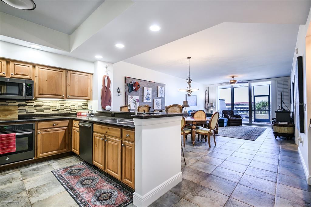 3313 Sunset Key Circle, Unit 104 Punta Gorda, FL 33955 - Photo 10 of 57 a kitchen with sink cabinets and dining table