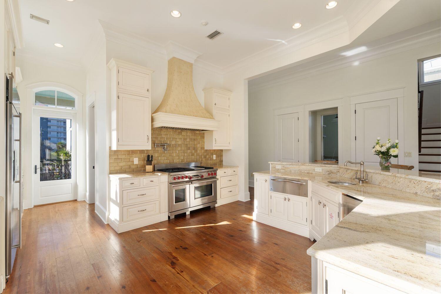 216 Sandtrap Road Miramar Beach, FL 32550 - Photo 12 of 66 a large kitchen with cabinets wooden floor and stainless steel appliances