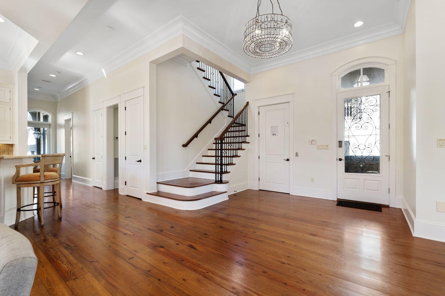 216 Sandtrap Road Miramar Beach, FL 32550 - Photo 8 of 66 a view of an empty room with wooden floor and stairs