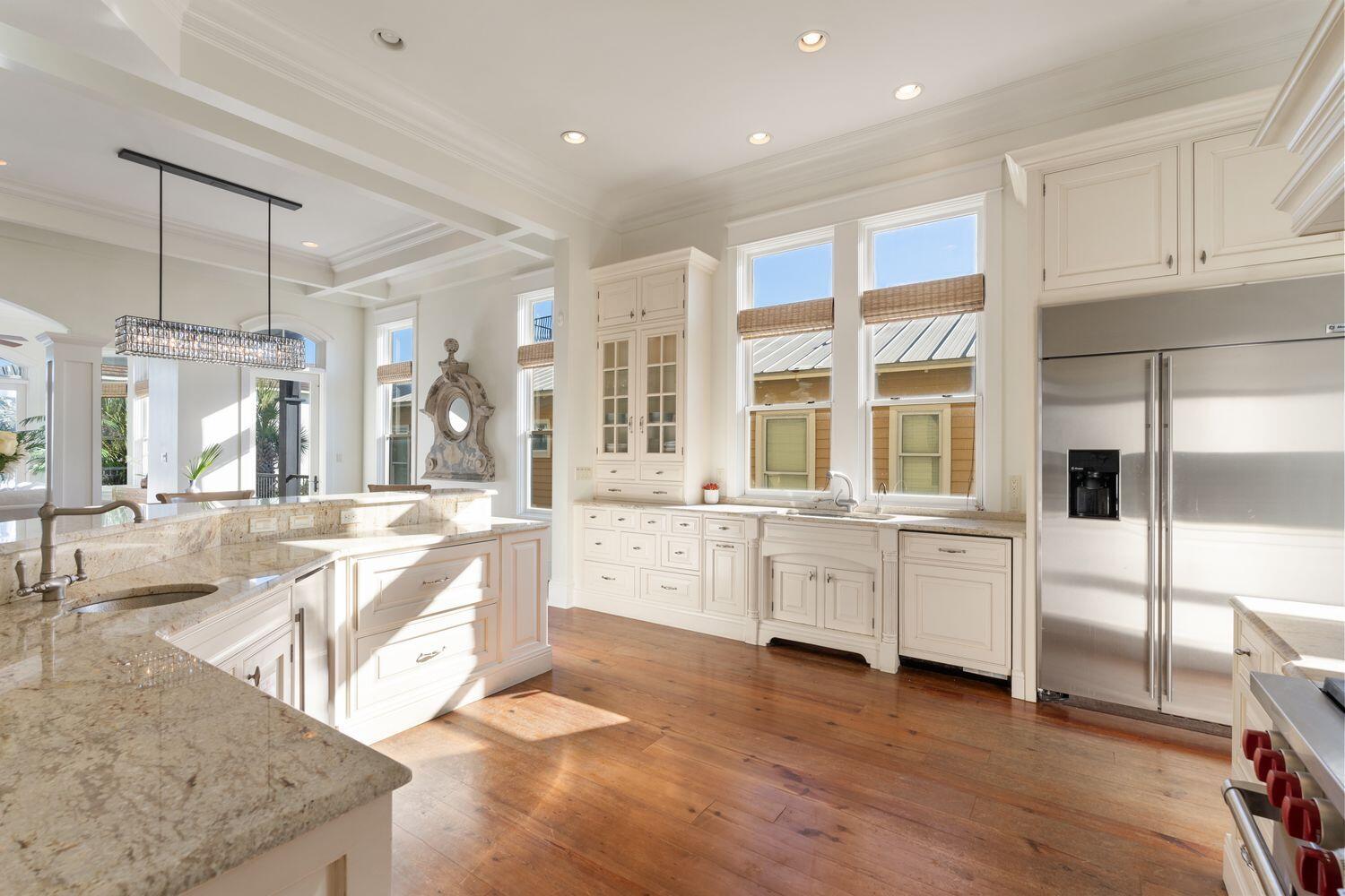 216 Sandtrap Road Miramar Beach, FL 32550 - Photo 10 of 66 a large white kitchen with granite countertop a sink and white cabinets