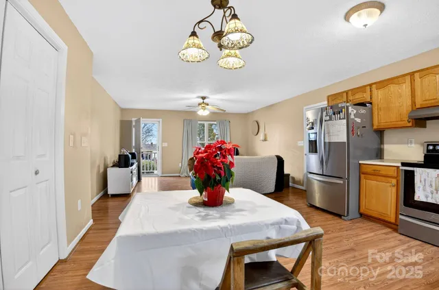 a kitchen with a table and refrigerator