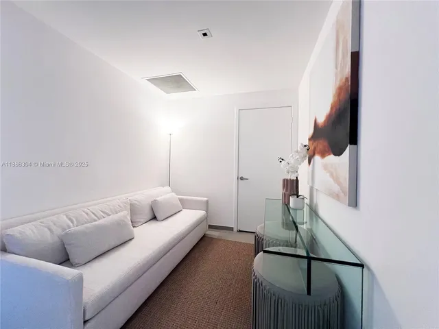 a living room with furniture and a floor to ceiling window