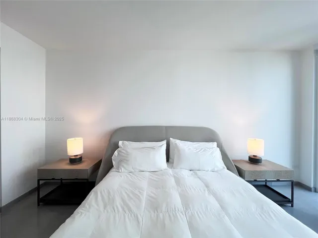 a bedroom with a bed and a lamp