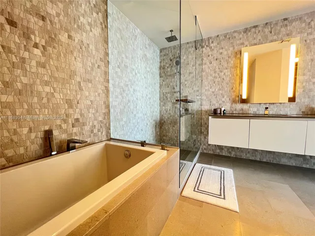 a bathroom with a bathtub and a shower