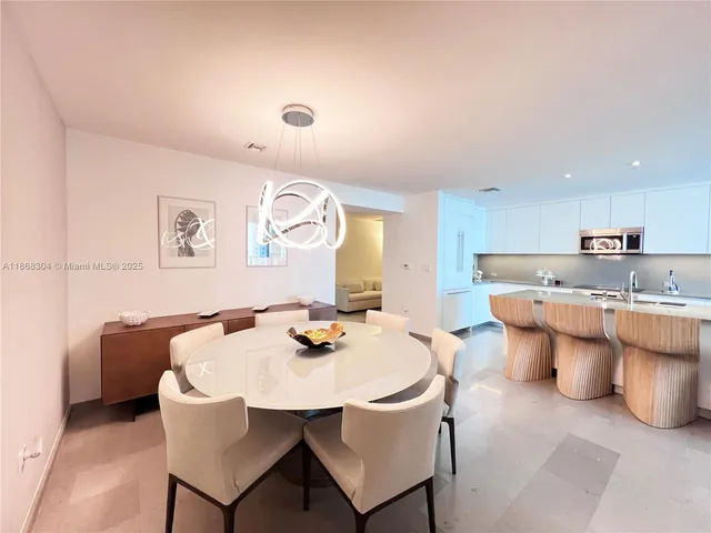 a kitchen with a table and chairs in it