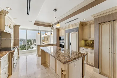 a kitchen with stainless steel appliances granite countertop a sink and refrigerator