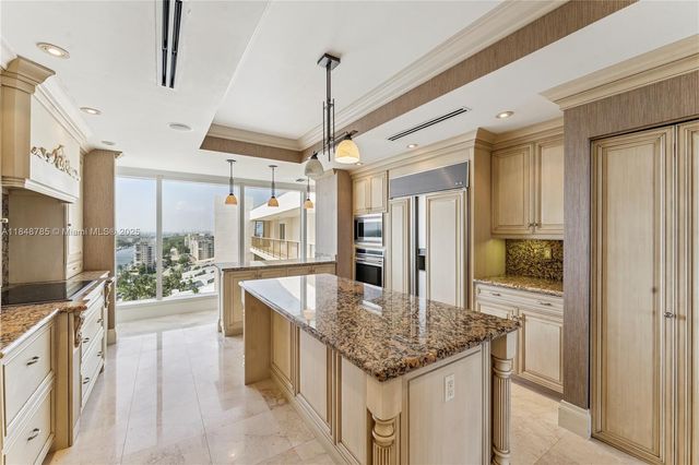 a kitchen with stainless steel appliances granite countertop a sink and refrigerator