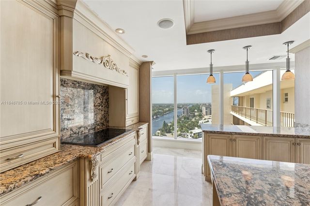 a view of a kitchen with a window and refrigerator