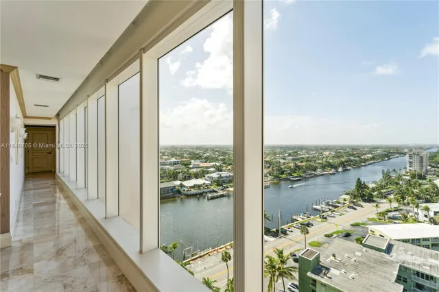 a view of a balcony with lake view and a floor to ceiling window