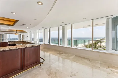 a view of a kitchen with a sink and large window