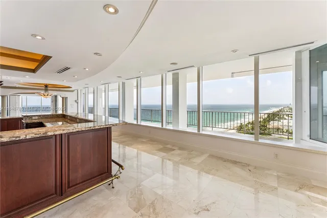 a view of a kitchen with a sink and large window
