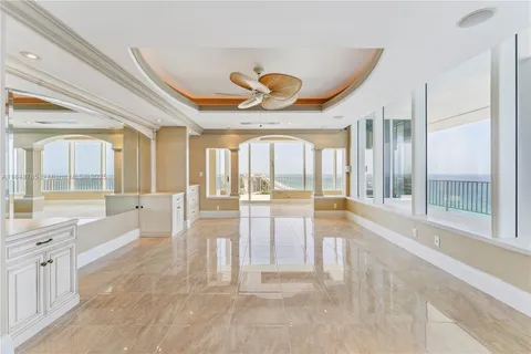 a large white kitchen with a large window