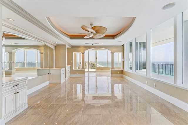 a large white kitchen with a large window