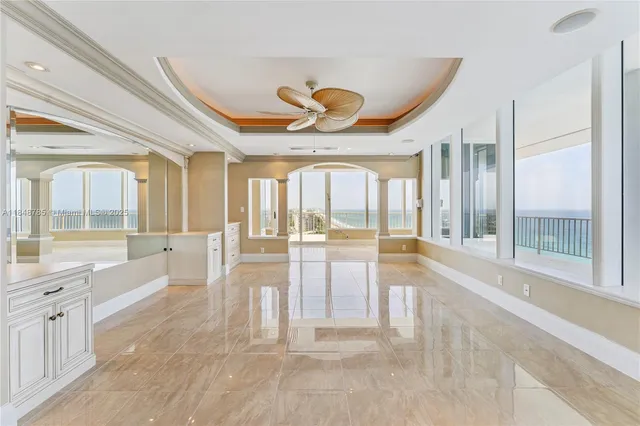 a large white kitchen with a large window