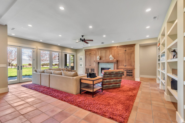 2579 Splendor Valley Road Kamas, UT 84036 - Photo 57 of 87 Living room featuring a fireplace, a ceiling fan, recessed lighting, french doors, and light tile patterned floors