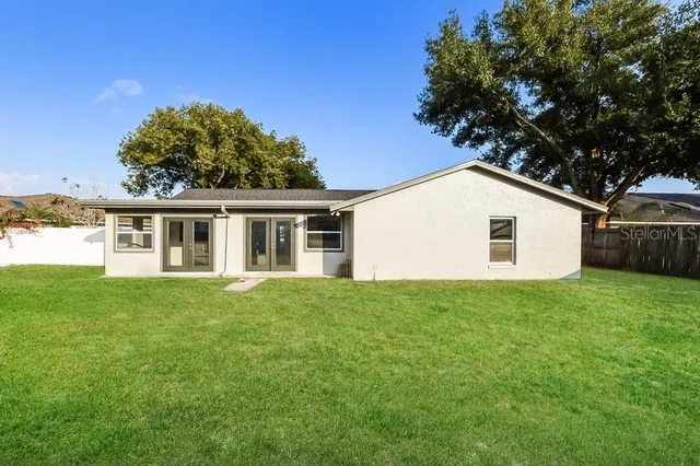 a view of a house with a backyard