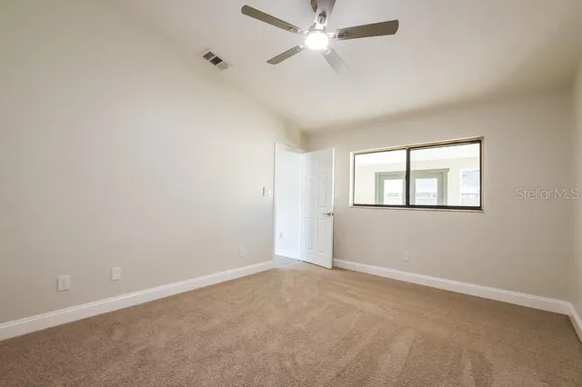 a view of an empty room with a window