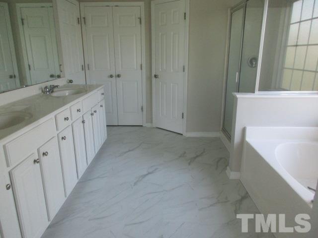 7714 San Gabriel Street Raleigh, NC 27613 - Photo 13 of 25 a bathroom with a sink and a tub