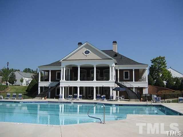 7714 San Gabriel Street Raleigh, NC 27613 - Photo 21 of 25 a front view of a house with a yard with swimming pool and outdoor seating