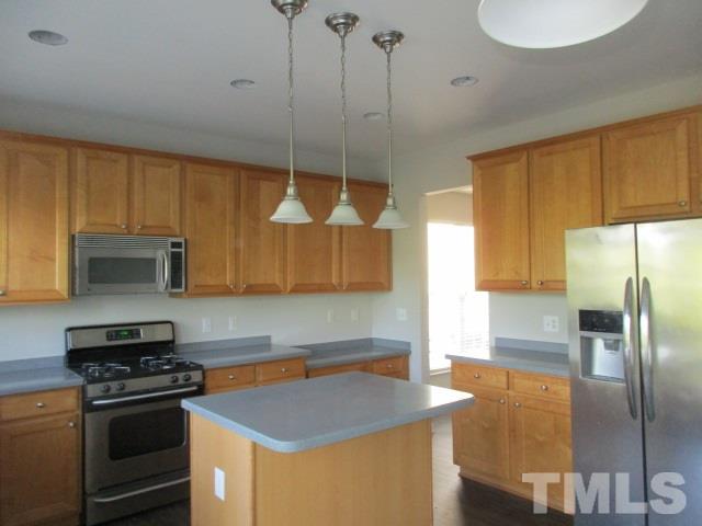 7714 San Gabriel Street Raleigh, NC 27613 - Photo 6 of 25 a kitchen with stainless steel appliances granite countertop a sink a stove and a refrigerator