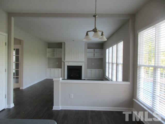 7714 San Gabriel Street Raleigh, NC 27613 - Photo 7 of 25 a view of empty room with fireplace and windows