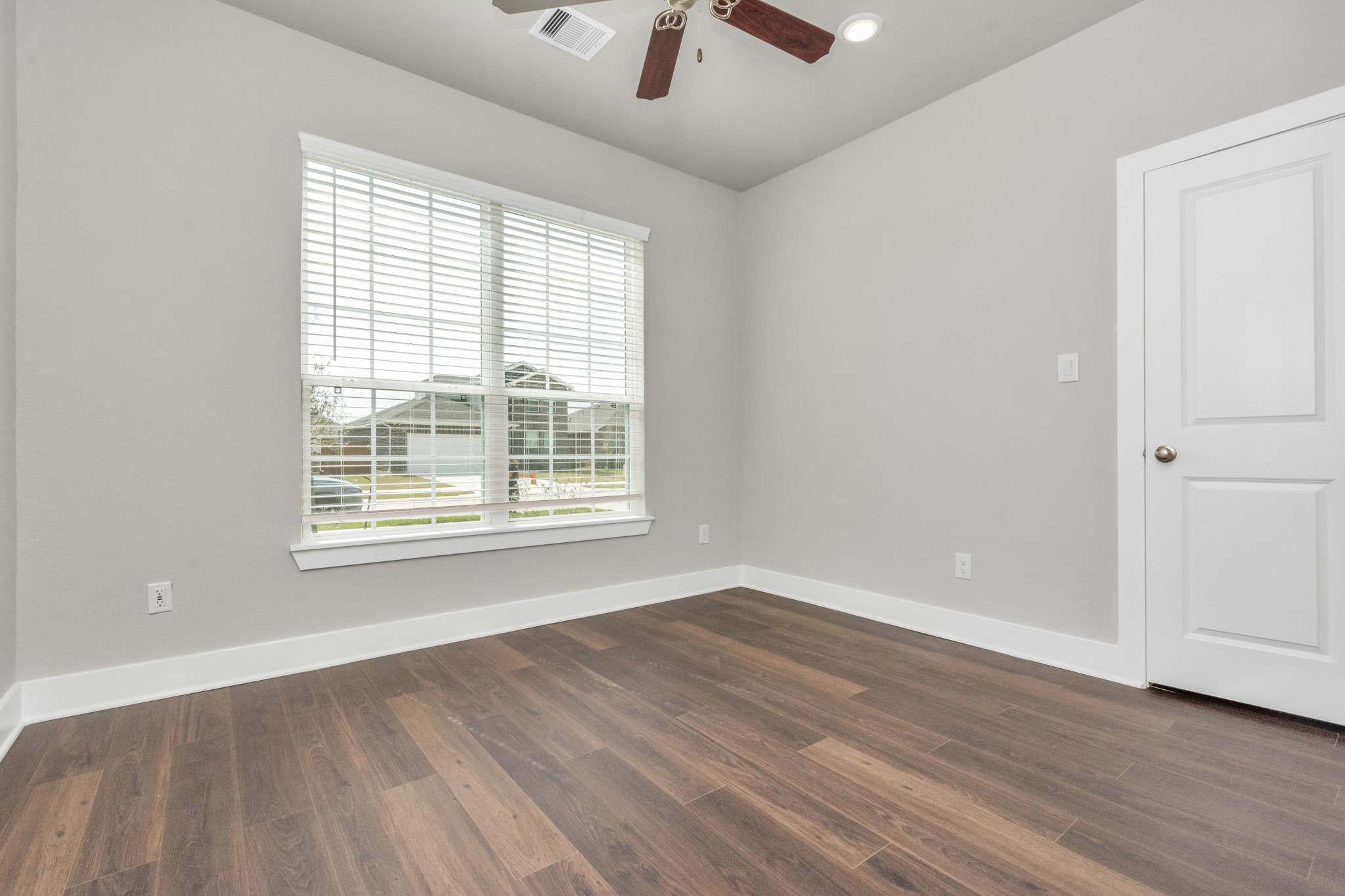 10638 Cascade Crk Drive Rosharon, TX 77583 - Photo 11 of 24 a view of an empty room with wooden floor and a window