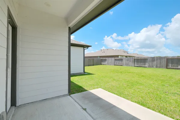 a view of an house with backyard space and balcony