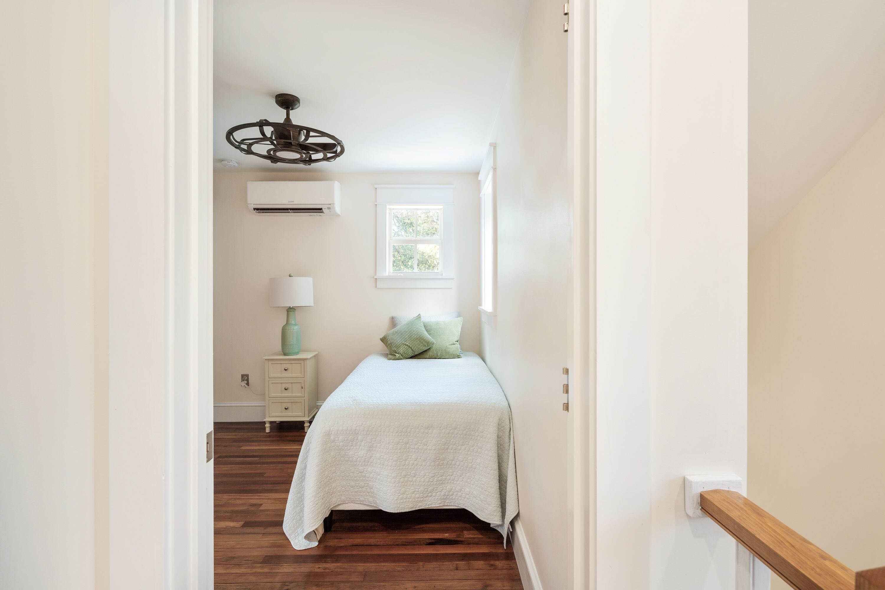 1007 Thomas Street Key West, FL 33040 - Photo 11 of 31 a bedroom with a bed and a chandelier