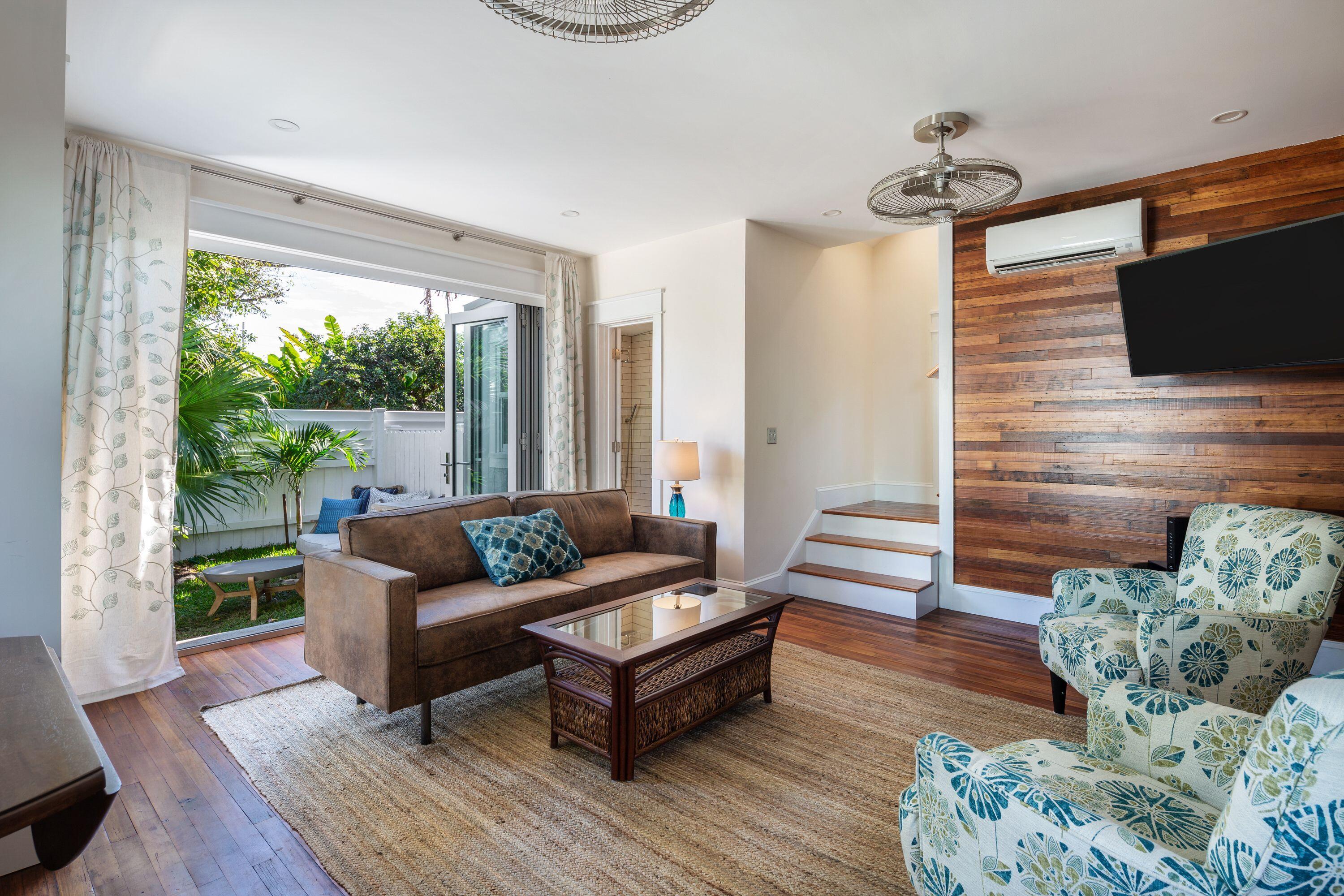 1007 Thomas Street Key West, FL 33040 - Photo 19 of 31 a living room with furniture and a flat screen tv