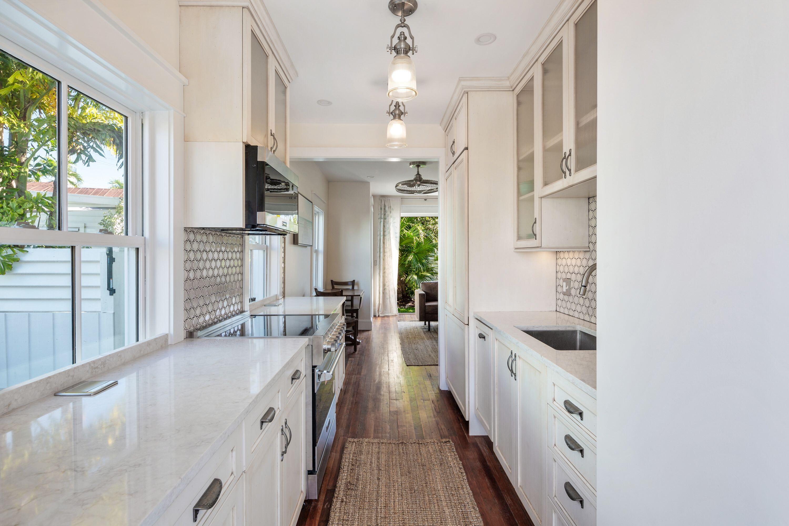 1007 Thomas Street Key West, FL 33040 - Photo 22 of 31 a large white kitchen with a large window