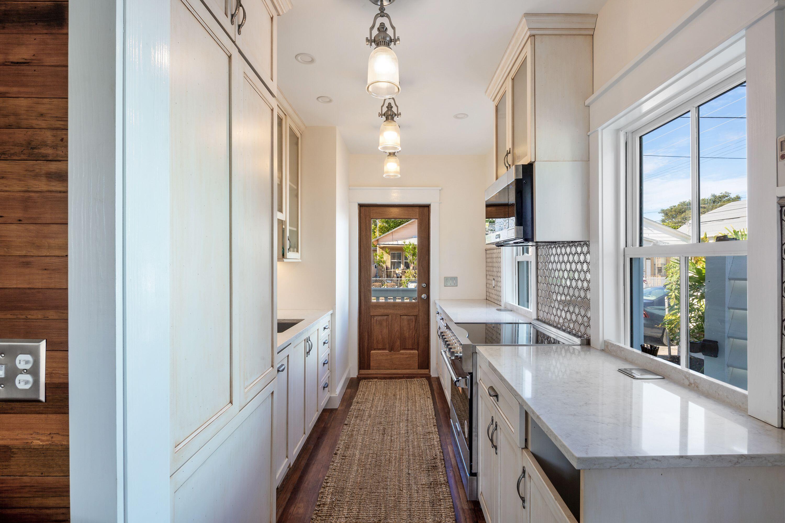 1007 Thomas Street Key West, FL 33040 - Photo 23 of 31 a kitchen with sink and refrigerator