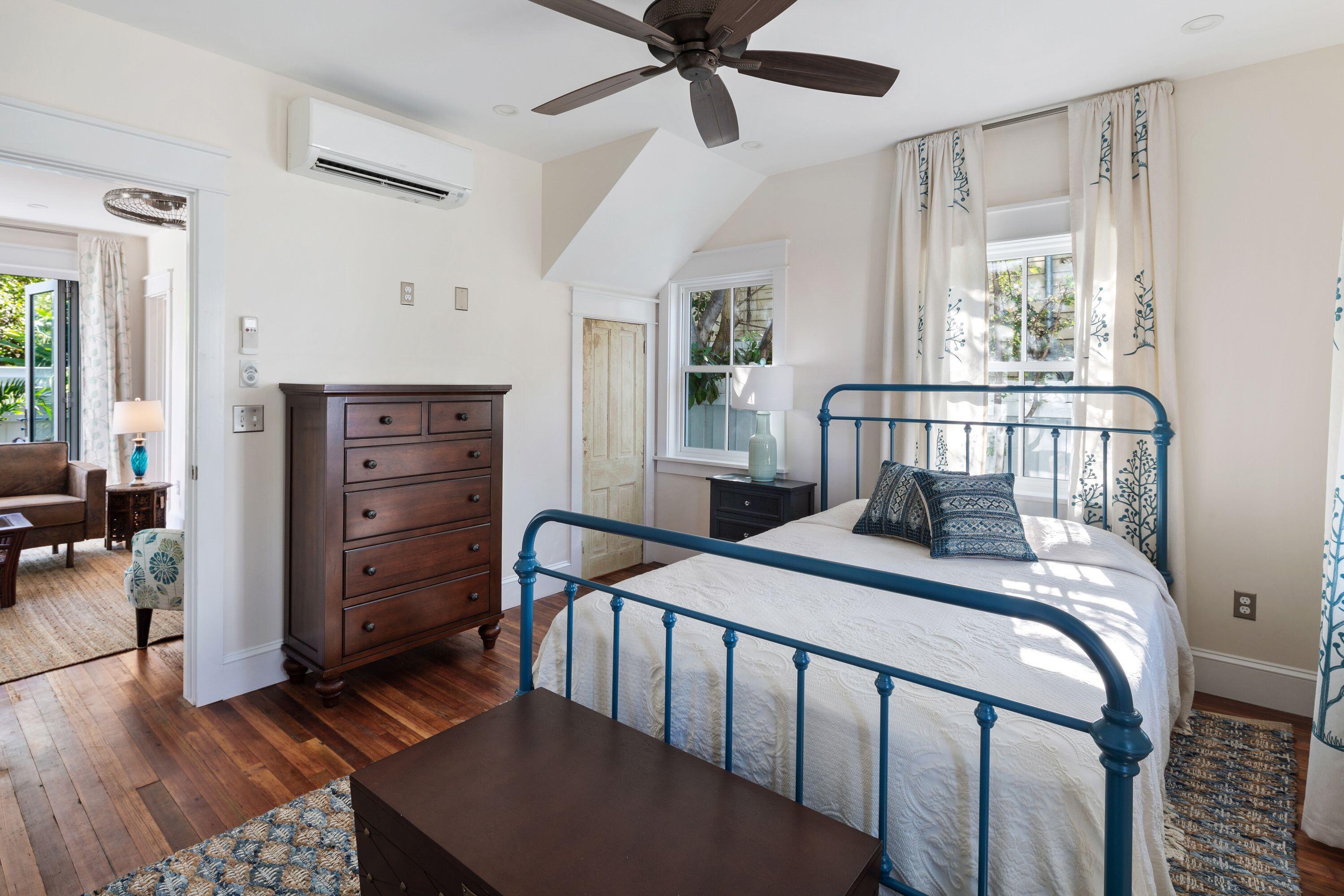 1007 Thomas Street Key West, FL 33040 - Photo 25 of 31 a bedroom with a bed and wooden floor