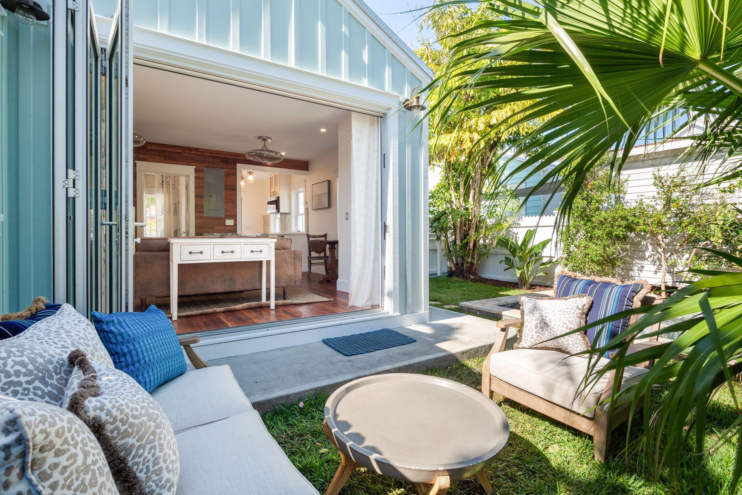 1007 Thomas Street Key West, FL 33040 - Photo 29 of 31 a backyard of a house with fireplace table and sofas