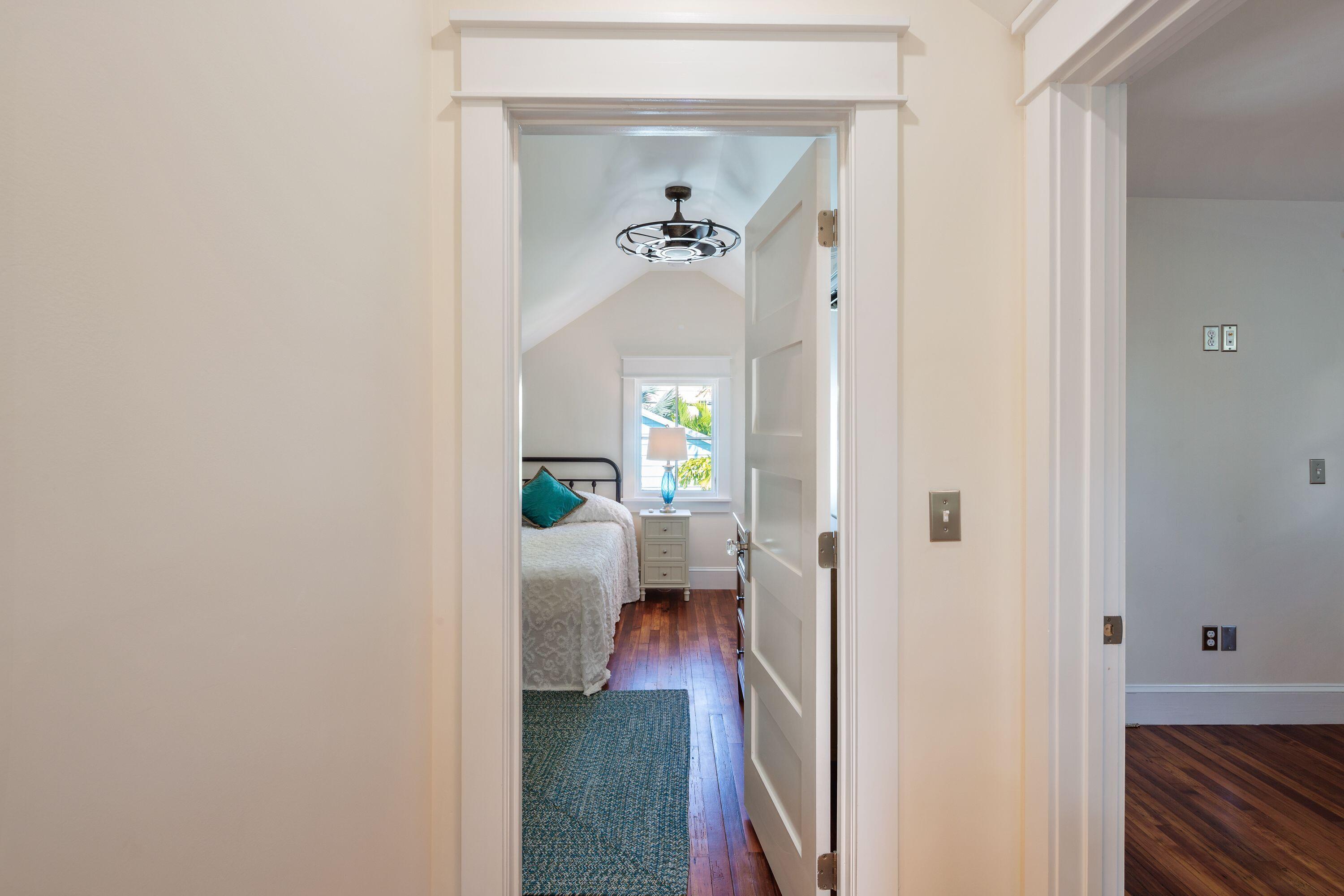 1007 Thomas Street Key West, FL 33040 - Photo 4 of 31 a view of a hallway with furniture and a chandelier fan