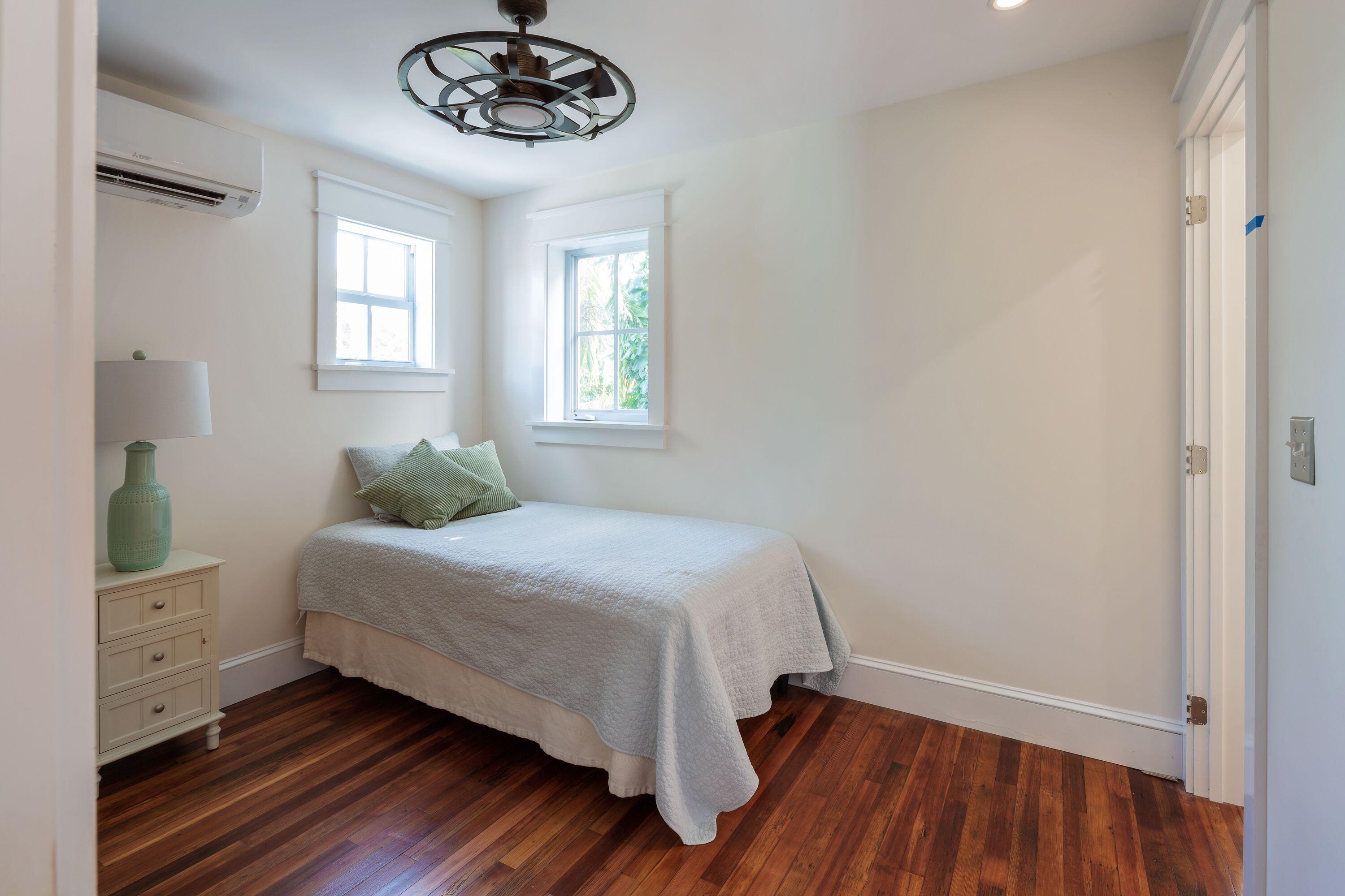 1007 Thomas Street Key West, FL 33040 - Photo 10 of 31 a bedroom with a bed and a chandelier