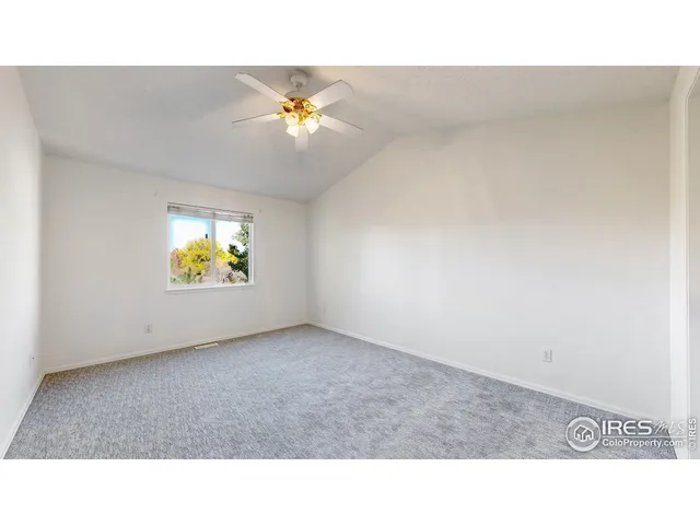 a open hall with a ceiling fan and a window
