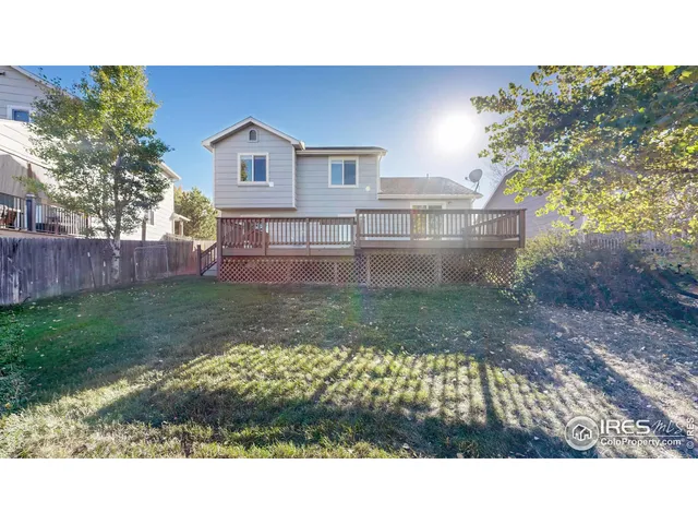 a aerial view of a house with a garden and lake view