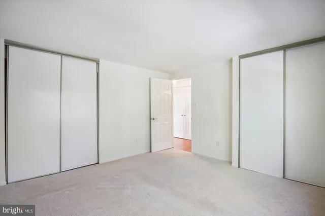a view of an empty room and closet area