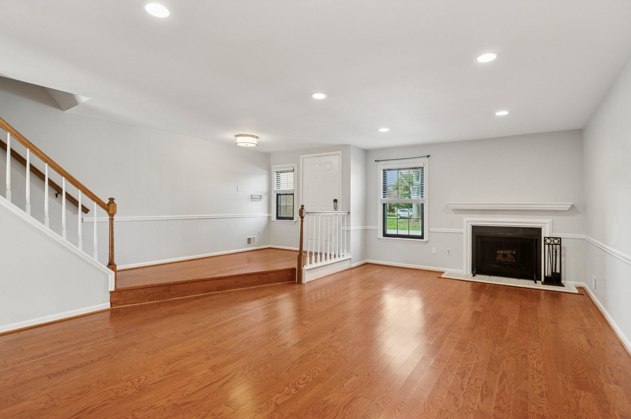 237 McIntosh Road, Unit 82 West Chester, PA 19382 - Photo 2 of 18 a view of an empty room with wooden floor fireplace and a window