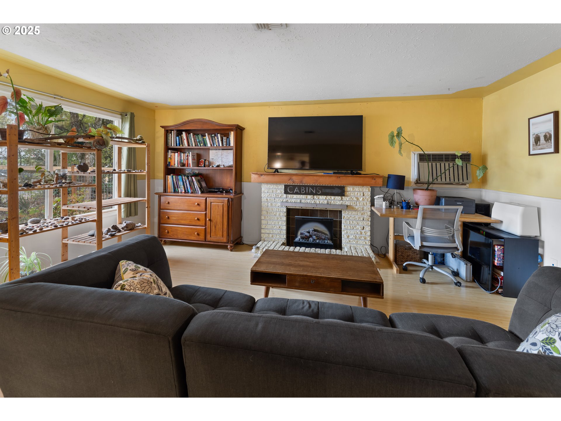 436 West M Street Springfield, OR 97477 - Photo 11 of 22 a living room with furniture a flat screen tv and a fireplace