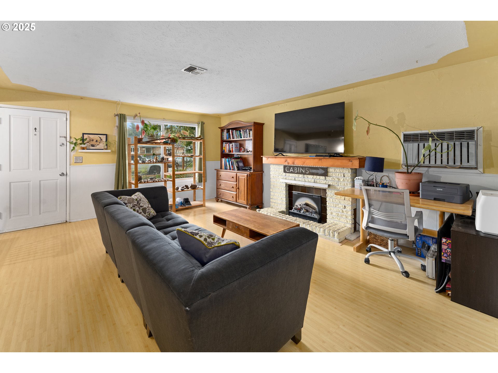 436 West M Street Springfield, OR 97477 - Photo 12 of 22 a living room with furniture a flat screen tv and a fireplace