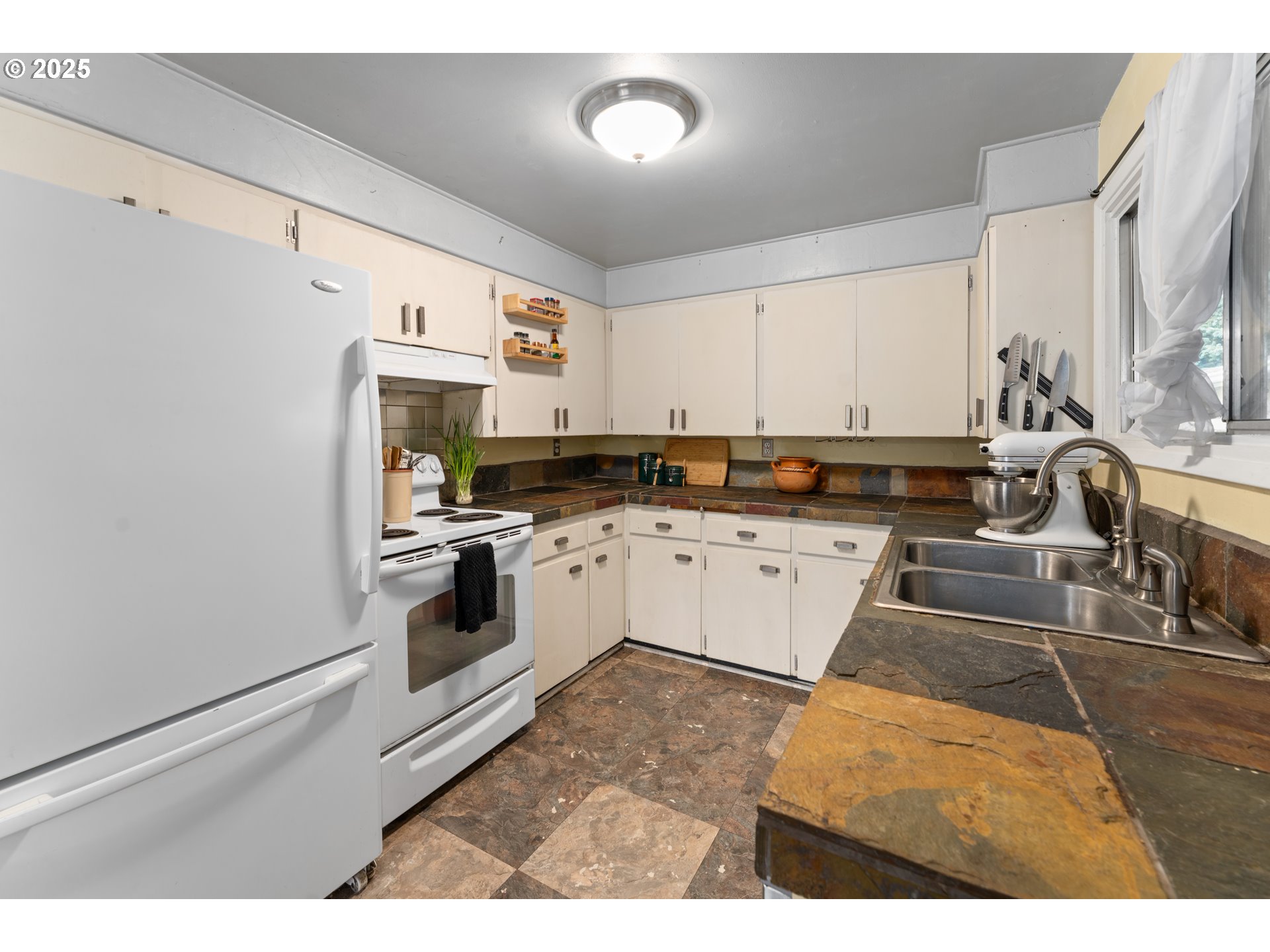 436 West M Street Springfield, OR 97477 - Photo 5 of 22 a kitchen with stainless steel appliances granite countertop a stove a sink and a refrigerator