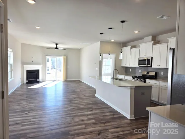 a view of kitchen with furniture and wooden floor