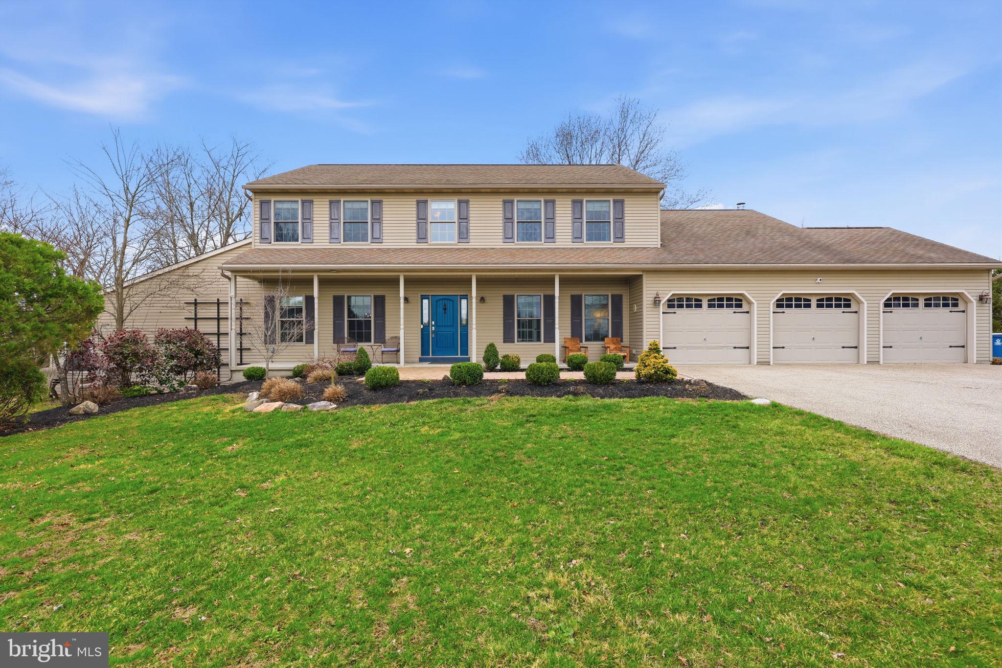 a view of a house with a yard table and chairs