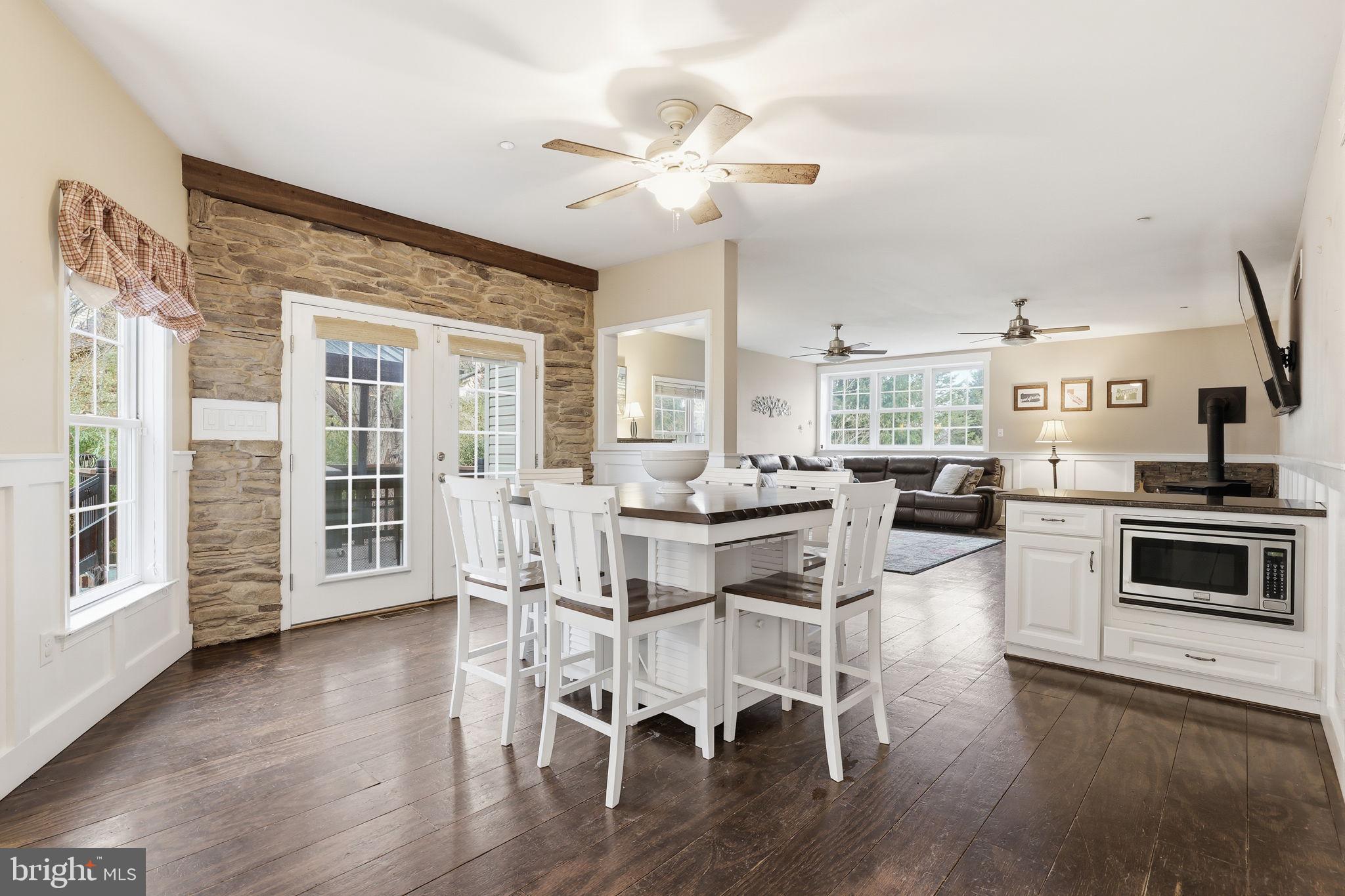 3852 Dark Hollow Road Furlong, PA 18925 - Photo 13 of 52 a dining room with wooden floor and chandelier