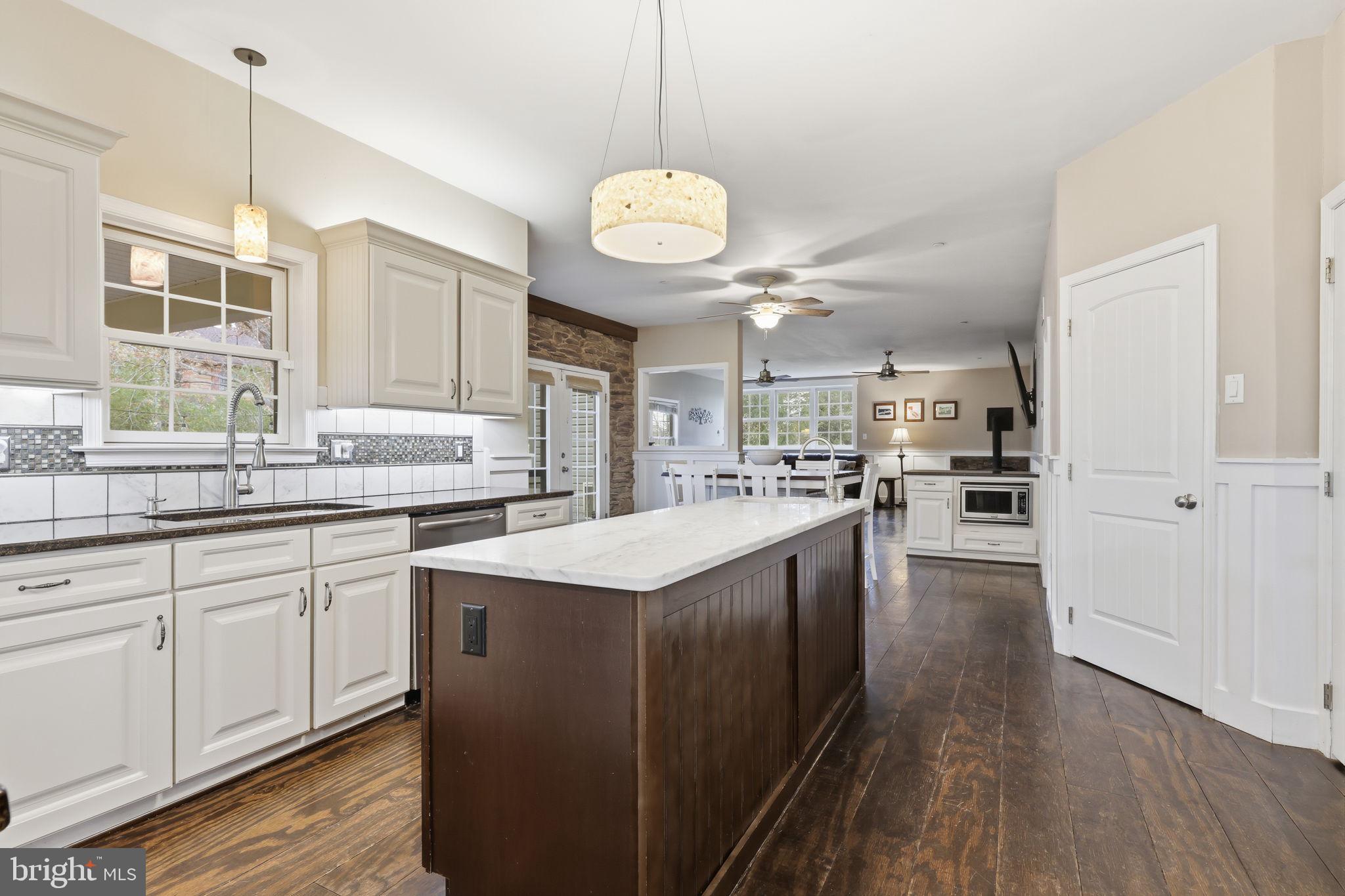 3852 Dark Hollow Road Furlong, PA 18925 - Photo 19 of 52 a kitchen with stainless steel appliances granite countertop a sink a stove and a wooden floors