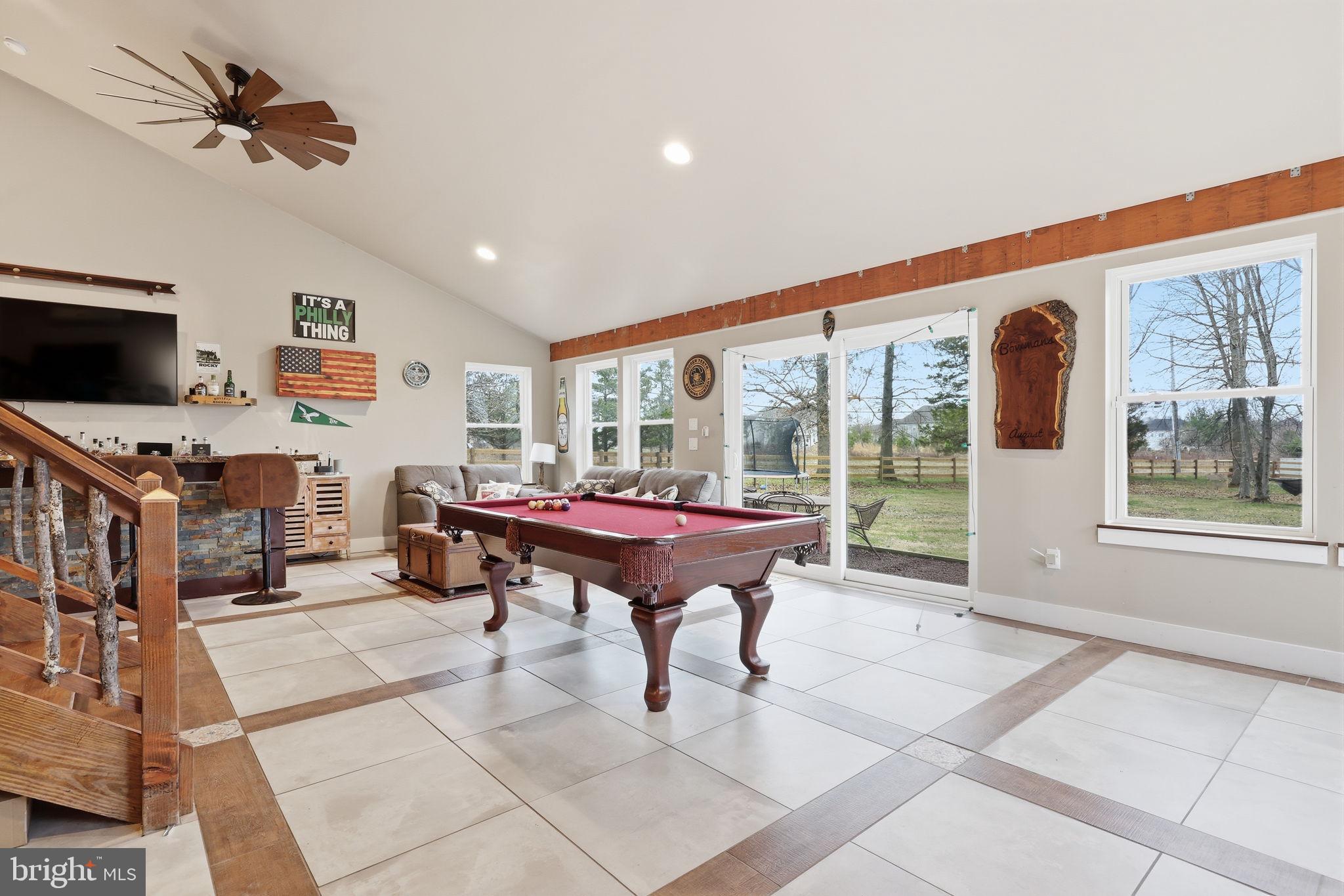 3852 Dark Hollow Road Furlong, PA 18925 - Photo 21 of 52 a living room with furniture a flat screen tv and a floor to ceiling window
