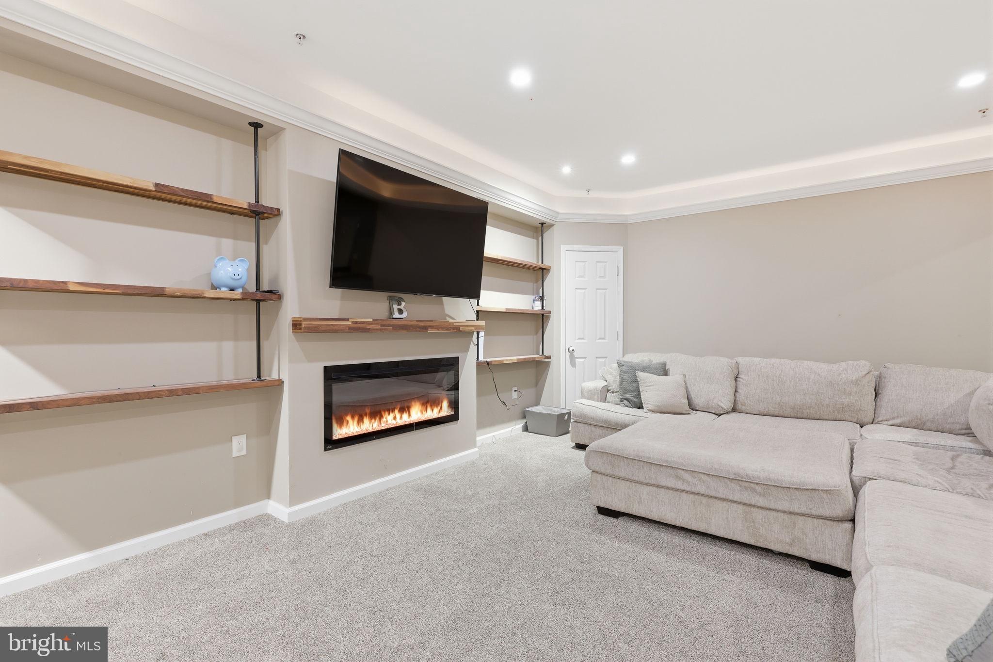 3852 Dark Hollow Road Furlong, PA 18925 - Photo 28 of 52 a living room with furniture a fireplace and a flat screen tv